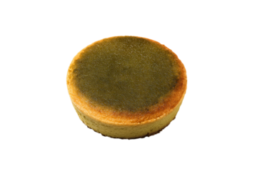 a cake with a green topping on a white surface
