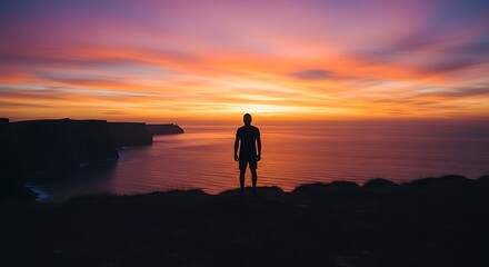 Fototapeta premium Silhouette on Rocky Cliff at Sunset – Serene Landscape of Reflection and Solitude