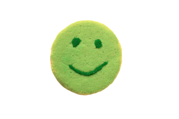a green cookie with a smiley face on it