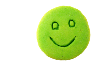 a green cookie with a smiley face drawn on it