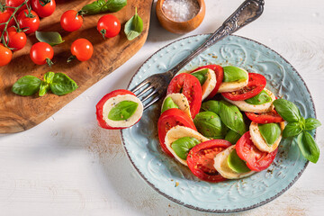Fresh Italian Caprese Salad on Wooden Background