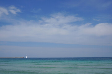 Obraz premium Calm Sea and Blue Sky with Lighthouse