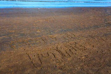 Beach sand features a heartfelt message written I love sea