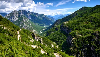 Obraz premium Mountain valley vista under a partly cloudy sky