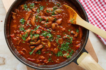Healthy chicken ragu in a delicious spicy bell pepper sauce in a skillet fresh and homemade cooked