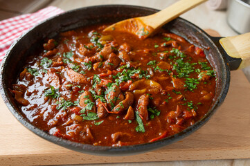 Healthy chicken ragu in a delicious spicy bell pepper sauce in a skillet fresh and homemade cooked