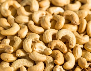 Fototapeta premium Close-up of cashews, showcasing their unique shape and inviting color ideal for themes of healthy snacks, vegan recipes, or wholesome ingredients. A collection of cashews, ready to be enjoyed 