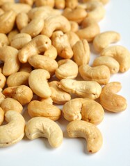 Fototapeta premium Close-up of cashews, showcasing their unique shape and inviting color ideal for themes of healthy snacks, vegan recipes, or wholesome ingredients. A collection of cashews, ready to be enjoyed 