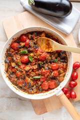 Eggplant, tomato ratatouille in a skillet fresh and homemade cooked. Healthy summer food