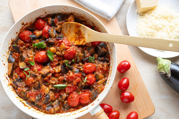 Eggplant, tomato ratatouille in a skillet fresh and homemade cooked. Healthy summer food