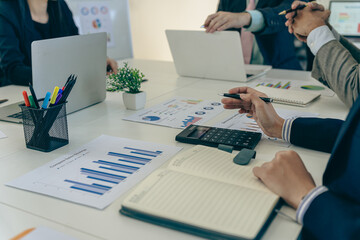 Business people discussing using financial document data charts and graphs. Business meeting. Financial analysis to determine business growth strategy and success.
