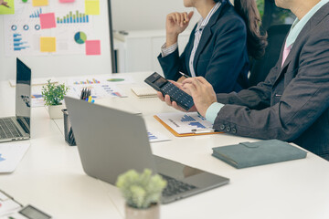 Business people discussing using financial document data charts and graphs. Business meeting. Financial analysis to determine business growth strategy and success.
