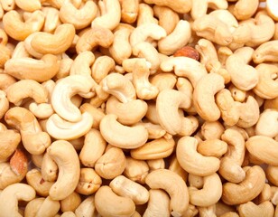 Close-up of cashews, showcasing their unique shape and inviting color ideal for themes of healthy snacks, vegan recipes, or wholesome ingredients. A collection of cashews, ready to be enjoyed 