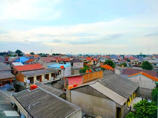 A tall, multi-story building that is visible from the residential area.