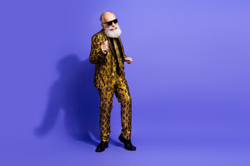 Stylish elderly man with white beard wearing a vibrant patterned suit on a purple background, exuding confidence and charisma