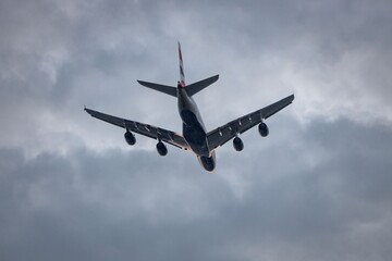 Airplane soaring through cloudy skies.