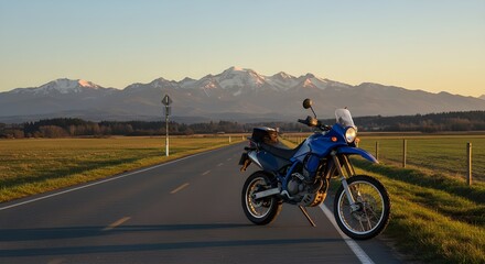 Obraz premium Motorcycle parked on a rural road with mountains in the background, adventure travel concept, scenic landscape, freedom on the road, wanderlust and exploration, perfect for illustrating outdoor journe