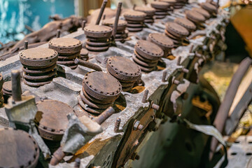 Close-up view of an aged aircraft engine, with multiple circular components Worn and corroded circles, natural lighting, realistic style, no additional objects or people