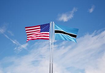 flags of  botswana and United States of America over blue sky background.
