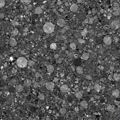 Gray speckled surface texture, filled with various-sized, dark and light gray circles and spots