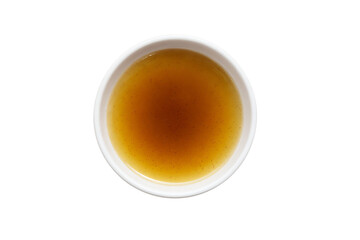 a cup of tea with a brown liquid