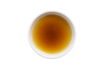 a cup of tea with a brown liquid