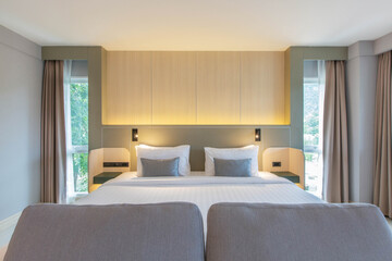 Fototapeta premium bedroom with two queen-sized beds, contemporary decor.