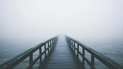 Obraz premium Foggy wooden pier extends into a vast, white expanse