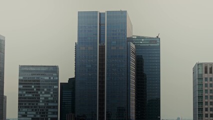 Fototapeta premium Top view of Tokyo business center. Modern glass skyscrapers from drone