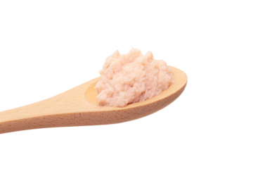 a wooden spoon with a small amount of pink sugar on it