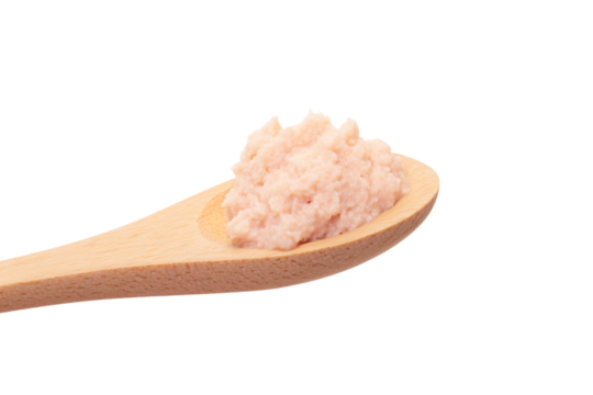 a wooden spoon with a small amount of pink sugar on it