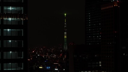 Drone view of the skyscrapers of the night city. Light in the windows