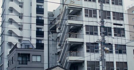 Fototapeta premium Facades of houses on a street in Tokyo, close-up. Residential area of the city