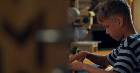 A child builds robot from construction kit. Home leisure