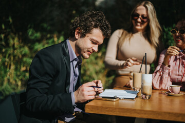 A diverse group of business colleagues discuss and collaborate during an outdoor meeting. The team is enjoying coffee, fostering creativity and teamwork in a relaxed environment.