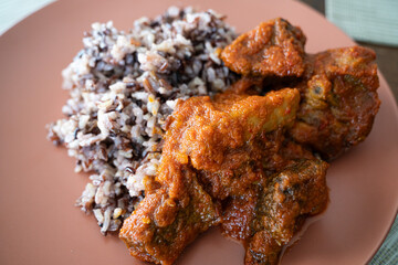 Wild rice served with spicy Nigerian tomato pepper stew