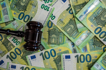 Close-up of multiple 100 euro banknotes spread out, symbolizing finance, savings, and investment