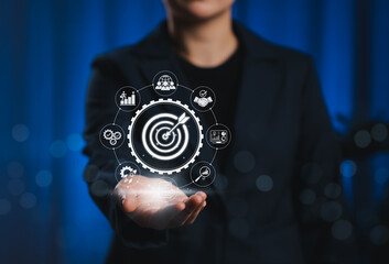 Business Goals and Target Success Strategy Concept. Businessperson presents target icon surrounded by symbols representing performance, objectives, growth, teamwork, analytics, and success metrics.