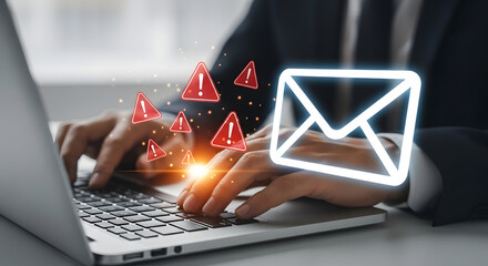 A person typing on a laptop with a digital envelope icon and warning symbols indicating a potential email threat.