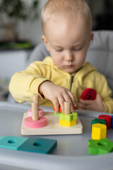 Little kid playing with educational toy, Cognitive skills, Montessori activity. Closeup, selective...