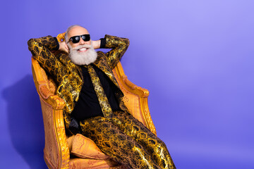 Elderly gentleman in a flamboyant golden suit portraying confidence and charisma while posing...