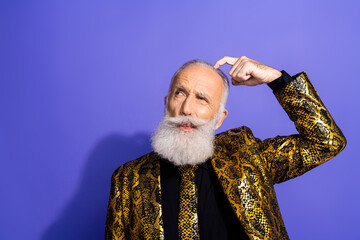 Charismatic senior man dressed in an extravagant gold patterned jacket gesturing thoughtfully...