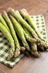 Fresh raw asparagus on wooden table, closeup