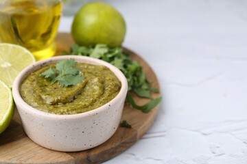 Tasty sauce with cilantro and other ingredients on white table, closeup. Space for text