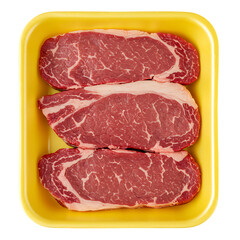 Obraz premium Fresh marbled beef steaks packaged in yellow container isolated