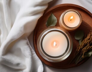 elegant flat lay of scented candles on white linen with towel for a serene atmosphere