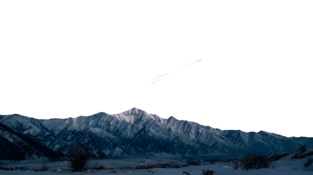 A brilliant meteor moving across a night sky above snowy mountains