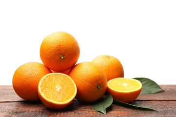Pile of juicy oranges and green leaves on wooden table against white background