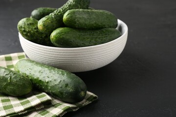 Fresh cucumbers on dark textured table, closeup