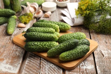 Making pickles. Fresh cucumbers and spices on wooden table, closeup